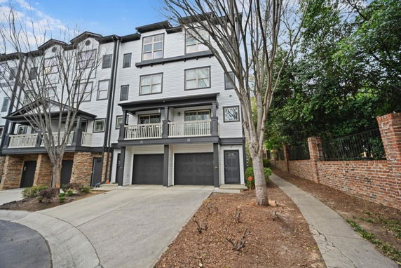 Front view of a multi-story townhouse with attached garages.