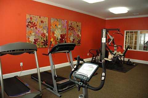 Indoor area with exercise equipment including treadmills and a weight machine.