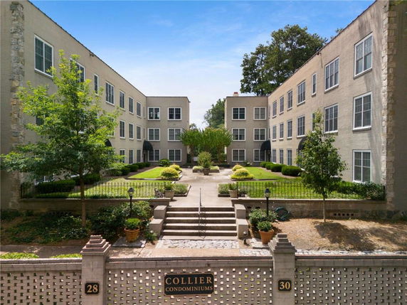 Front view of a multi-story condominium complex with courtyard.