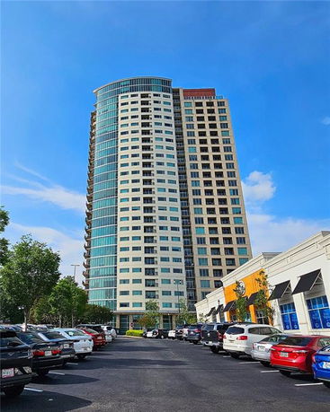 Front view of a tall multi-story building with a curved facade.