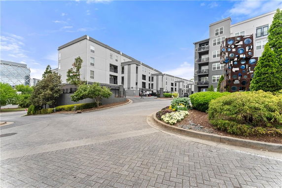 Front view of a multi-story apartment building with modern architecture.
