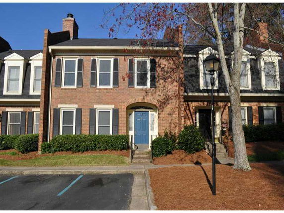 Front view of a two-story townhouse with brick exterior.