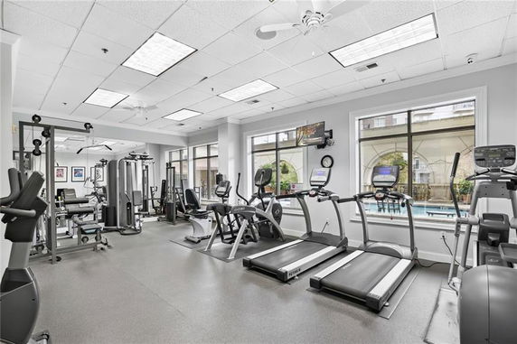 Indoor gym with various exercise equipment including treadmills and weight machines.