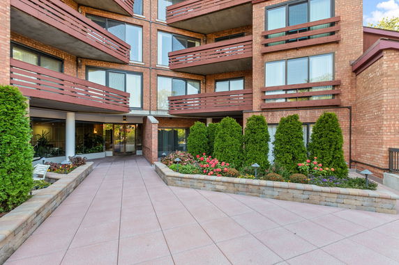 Front view of a multi-story brick building with balconies.
