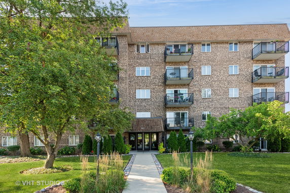 Front view of a multi-story residential building with balconies.