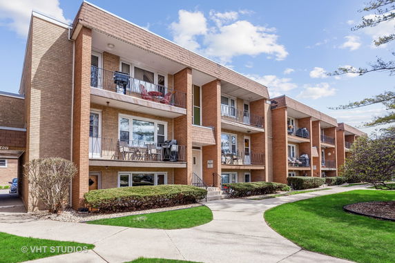 Front view of a multi-story apartment building with balconies