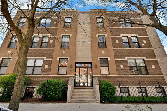 Front view of a three-story brick apartment building.