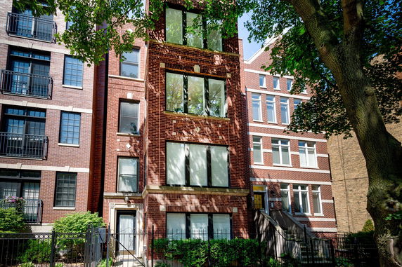 Front view of a multi-story brick apartment building.