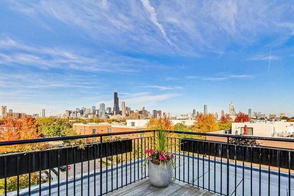 Panoramic view from a rooftop overlooking a city skyline.