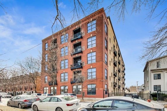Front view of a multi-story brick apartment building.