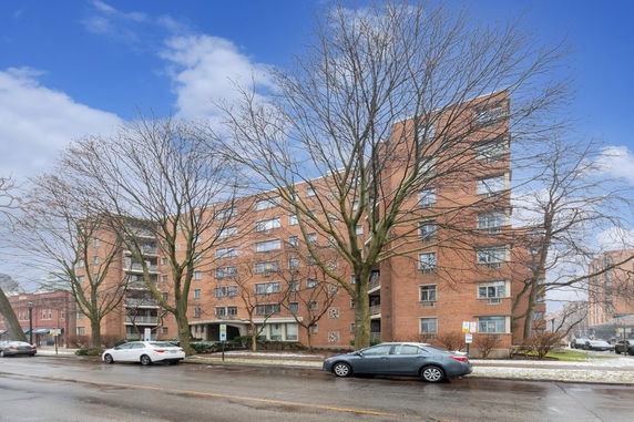 Front view of a multi-story brick apartment building.