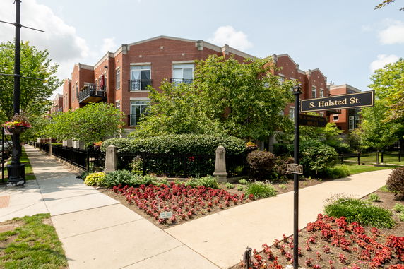 Front view of a brick residential building with multiple balconies.