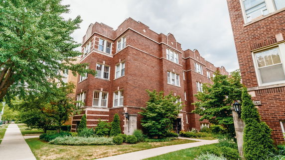Front view of a multi-story brick apartment building.