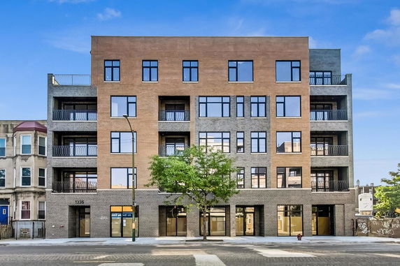 Front view of a multi-story apartment building with a modern design.