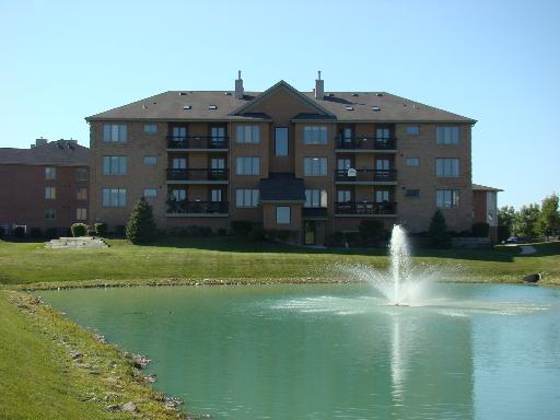 Front view of a multi-story apartment building with balconies.