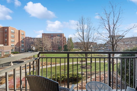 Panoramic view from a balcony overlooking a courtyard and surrounding buildings.