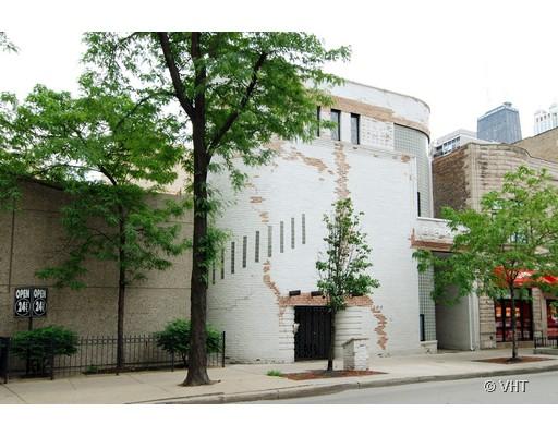 Front view of a two-story white brick building with decorative masonry.