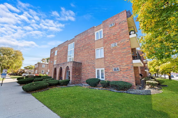 Front view of a three-story brick apartment building.