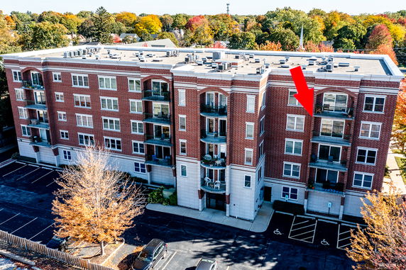 Front view of a multi-story brick building with balconies.