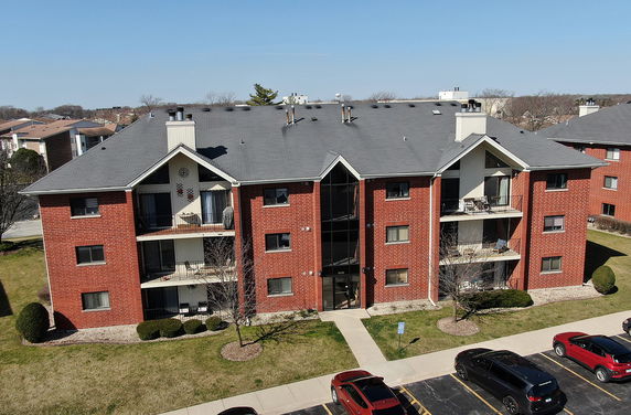 Front view of a multi-story brick apartment building.