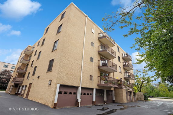 Front view of a multi-story brick building with balconies.