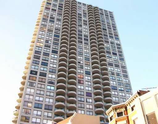 Front view of a high-rise residential building with multiple balconies.