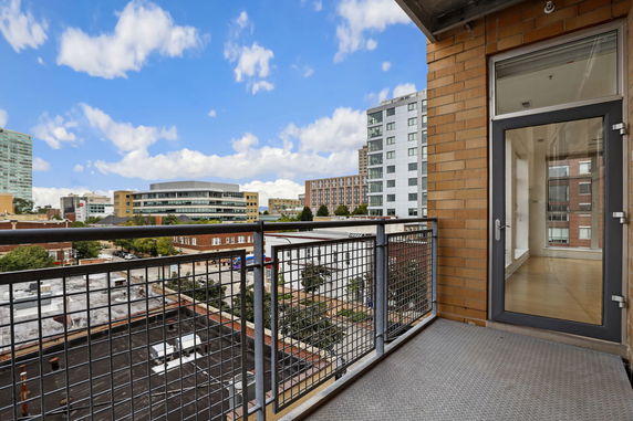 View from a balcony overlooking urban buildings and streets.