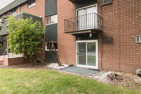 Front view of a brick apartment building with balconies.