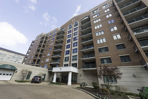 Front view of a multi-story apartment building with balconies.
