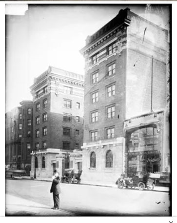 Front view of multi-story brick buildings with architectural details.