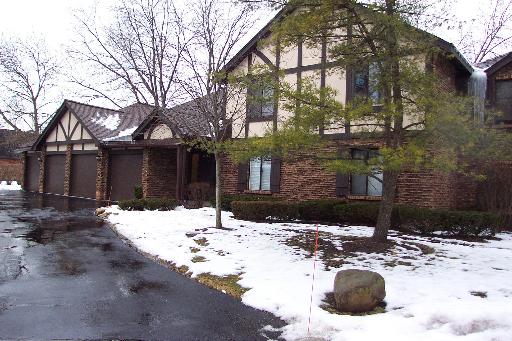 Front view of a two-story house with multiple gables and a three-car garage.
