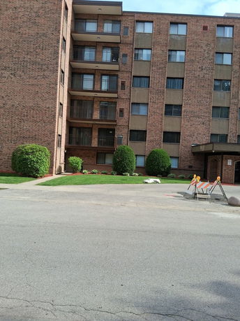 Front view of a multi-story brick apartment building.