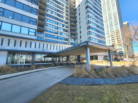 Front view of a multi-story building with a covered entrance.