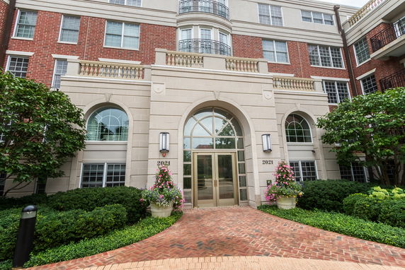 Front view of a multi-story building with a grand entrance.