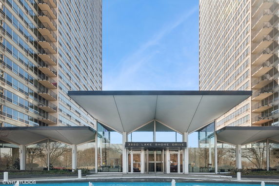 Front view of a modern high-rise building with a prominent entrance.