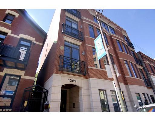 Front view of a multi-story brick building with large windows and balconies.