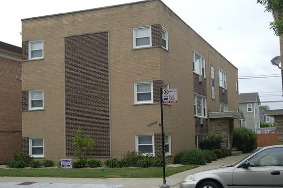 Front view of a two-story brick apartment building.