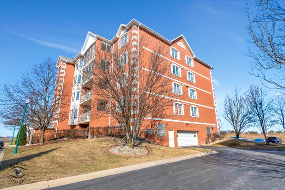 Front view of a multi-story brick apartment building.