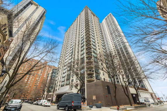 Front view of a high-rise residential building with multiple balconies.