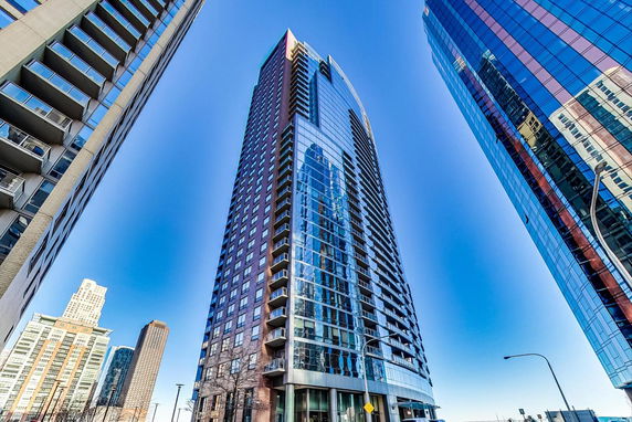 Front view of a tall residential and commercial high-rise building.
