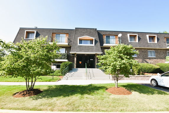 Front view of a two-story apartment building with multiple balconies.