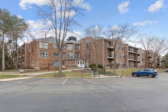 Front view of a multi-story brick apartment building.