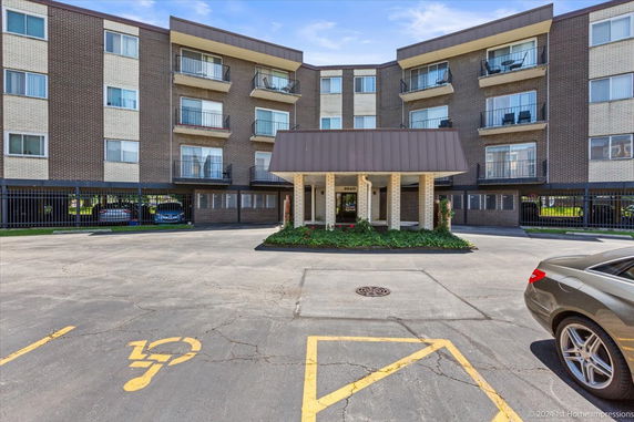 Front view of a multi-story residential building with balconies.