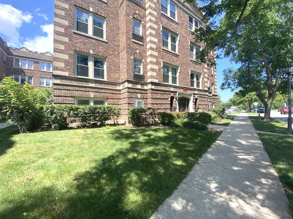 Front view of a multi-story brick apartment building.