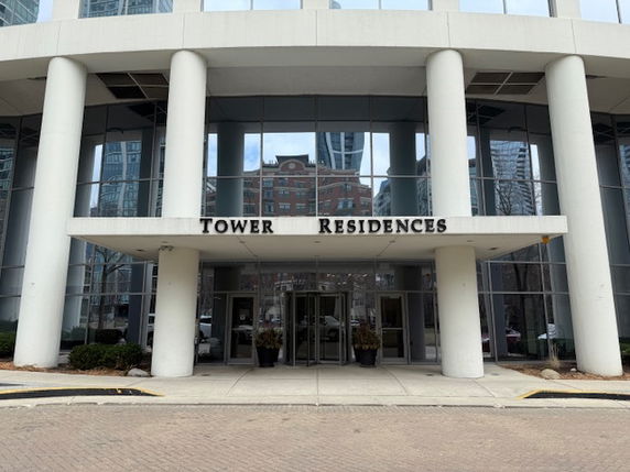 Front view of a multi-story building entrance labeled Tower Residences.