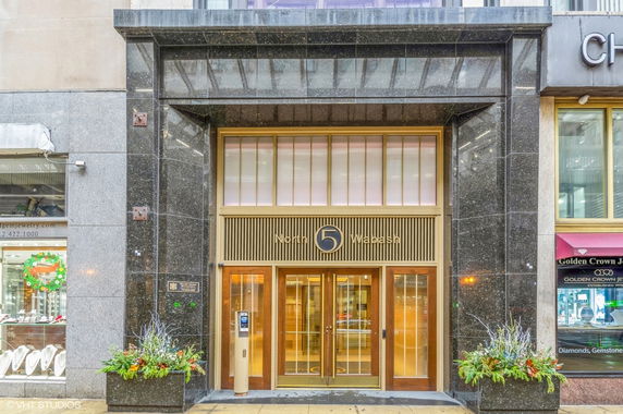 Front view of a commercial building entrance with modern design elements.