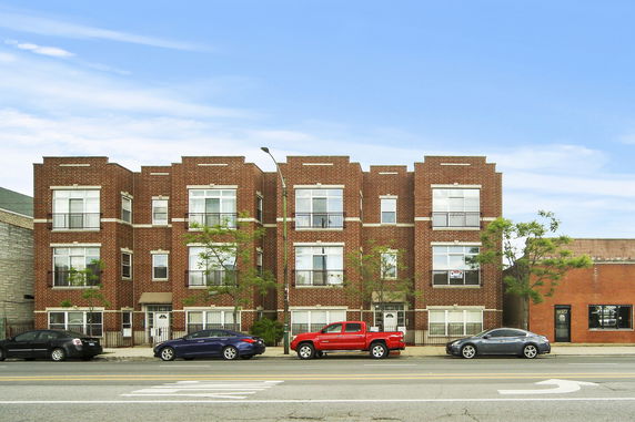 Front view of a three-story brick apartment building.