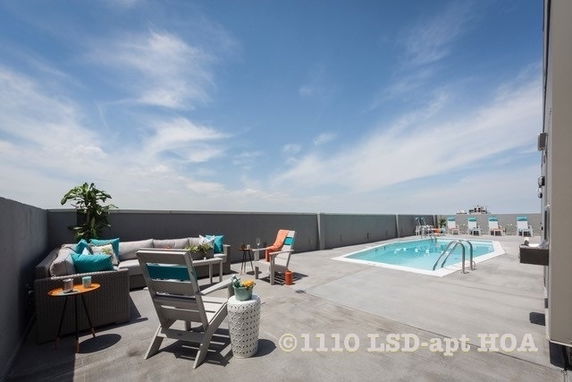 Rooftop area with seating and a swimming pool.