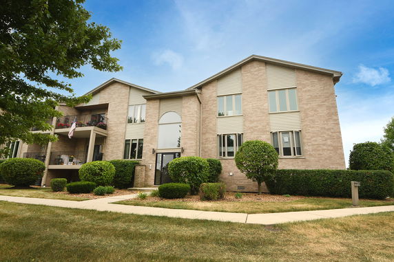 Front view of a multi-story brick apartment building.