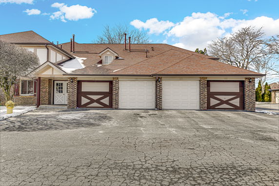 Front view of a house with a three-car garage.